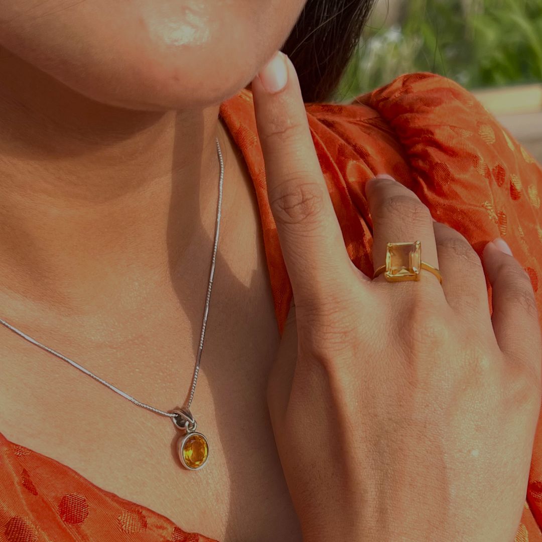 A girl wearing beautiful natural golden topaz ring and a pendant